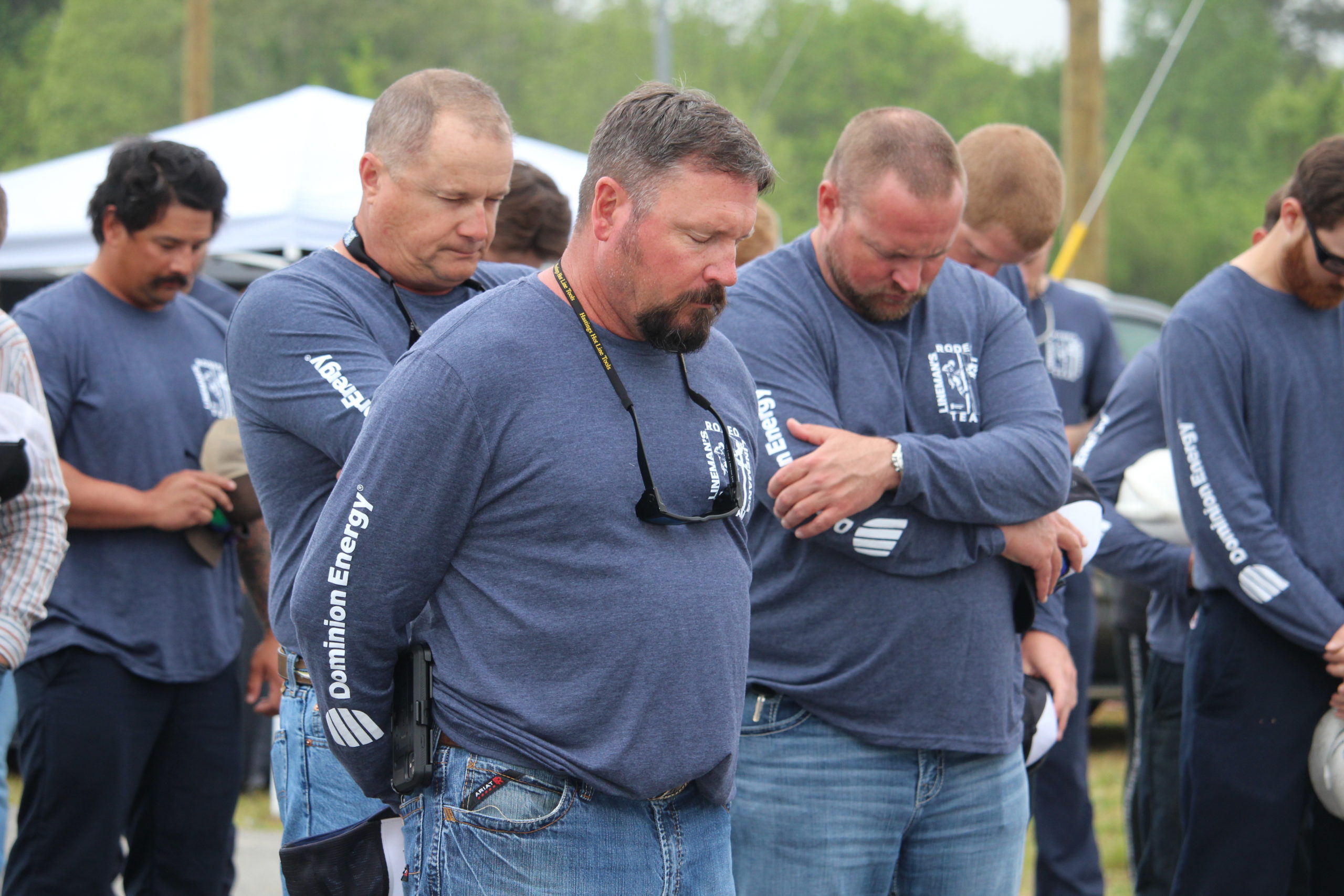 Dominion Energy linemen bow their heads respectfully during the morning invocation by Pastor Randy Holloway.