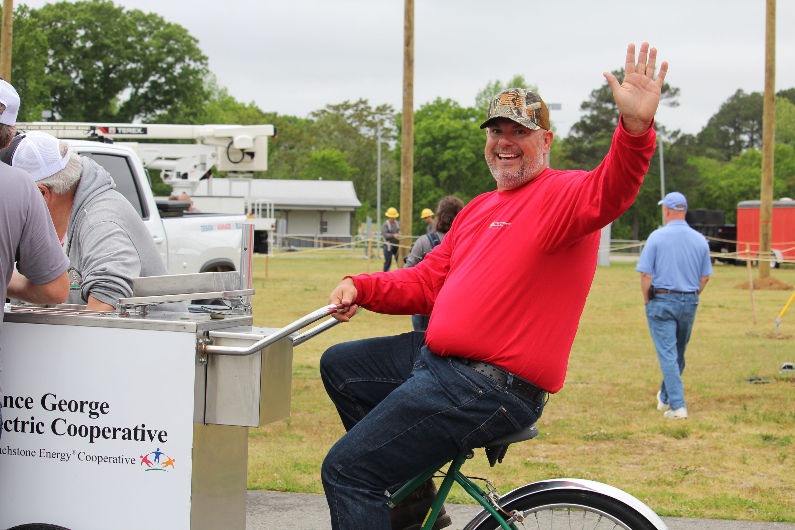 Casey Logan, President & CEO of Prince George Electric Cooperative, greets everyone as he cruises through the Gaff-n-Go Lineworker’s Rodeo on the PGEC icecream bike offering up sweet treats.