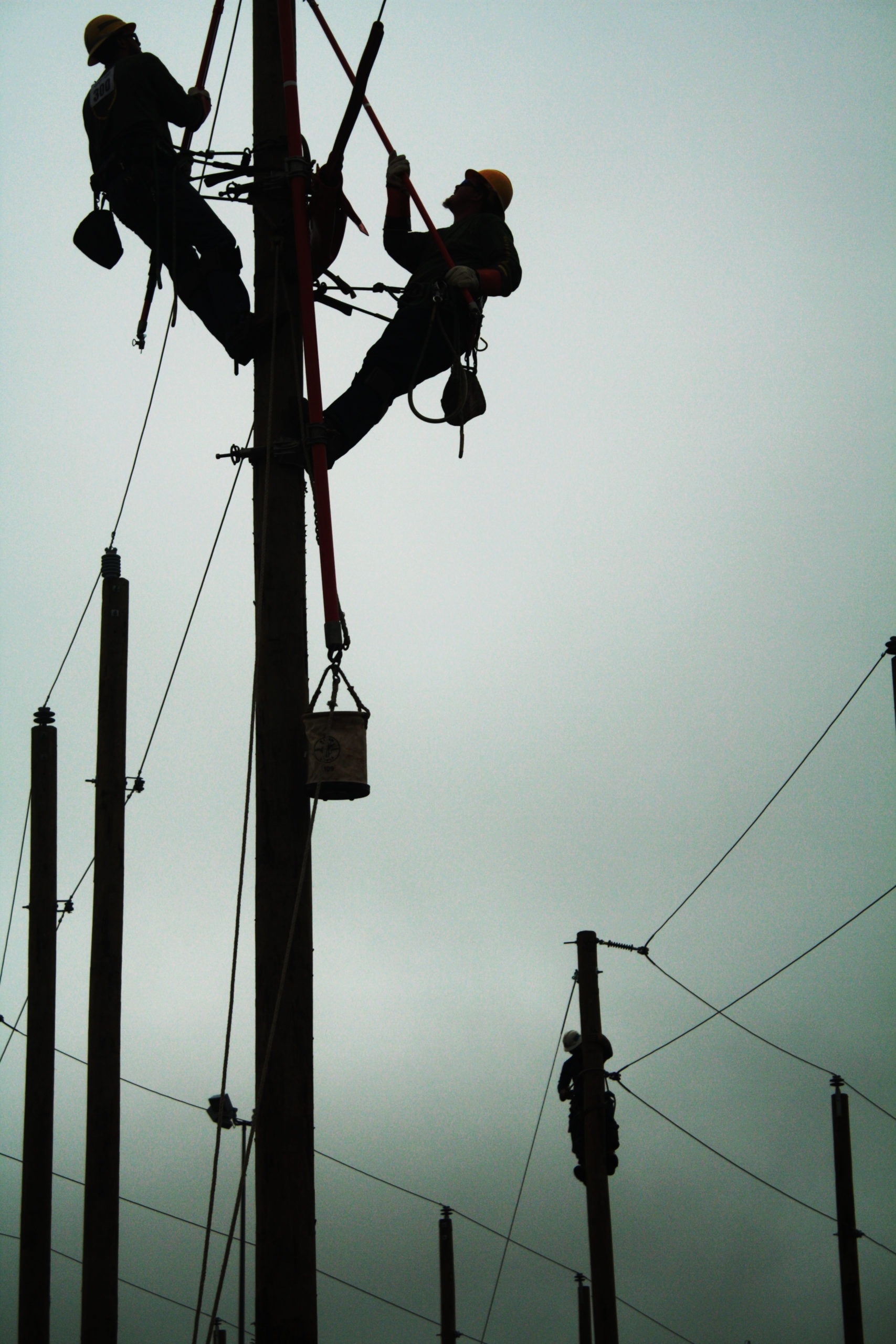 Silhouette -  Lineworkers doing what they do